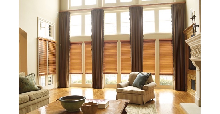 Boise great room with wood blinds and floor to ceiling drapes.